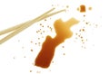 Splashes of soy sauce and chopsticks isolated on white background, top view Royalty Free Stock Photo