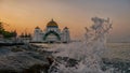 Splashes at Straits Mosque of Malacca during sunrise. Royalty Free Stock Photo