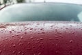 Splashes and water drops on a red car Royalty Free Stock Photo