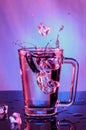 Splashes of water. Falling ice cubes into a glass of water on a Royalty Free Stock Photo