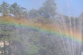 Splashes of water from fountain and reflection rainbow in sunlight close-up. Fog view, beautiful background, blur Royalty Free Stock Photo