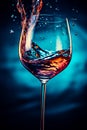 Splashes of water in a wine glass, with blue filter, close up with copy space