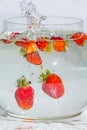 Splashes and Whirls of Bunch of Strawberries Thrown in Water Tank