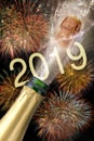 Bottle of champagne with flying cork and firework at Silvester 2019 Royalty Free Stock Photo