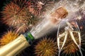 Bottle of champagne with flying cork and firework at Silvester 2019 Royalty Free Stock Photo