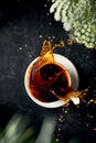 splashing cup of coffee from top view on the dark background Royalty Free Stock Photo