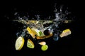 Splashing fruit on water. Royalty Free Stock Photo