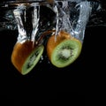 Splashing kiwi fruit on the water Royalty Free Stock Photo