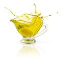 Splashing olive oil in transparent jar isolated on white with clipping path Royalty Free Stock Photo