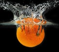 Splashing orange into a water Royalty Free Stock Photo