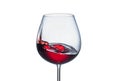 Splashing red wine in a glass on a white background close-up Royalty Free Stock Photo