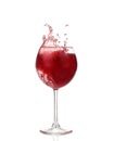 Splashing red wine in a glass. Isolated on white background Royalty Free Stock Photo