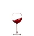 Splashing red wine in a glass. Isolated on white background Royalty Free Stock Photo