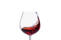 Splashing red wine in a glass on a white background close-up Royalty Free Stock Photo