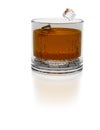 Splashing scotch. 3D illustration. Ice cubes fall into a glass of whiskey on white