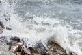 Splashing sea wave hitting rocks on the beach shore. Royalty Free Stock Photo