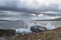 Splashing sea waves with Russkiy bridge on background