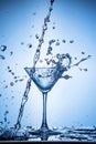 Splashing water on blue background. Royalty Free Stock Photo