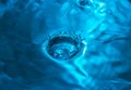 Splashing water drops in blue color Royalty Free Stock Photo