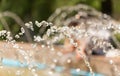 Splashing water from a fountain against the blue sky Royalty Free Stock Photo