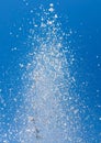 Splashing water from a fountain against the blue sky Royalty Free Stock Photo