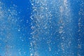 Splashing water from a fountain against the blue sky Royalty Free Stock Photo