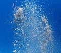 Splashing water from a fountain against the blue sky Royalty Free Stock Photo