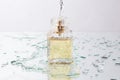 Splashing water on perfume bottle Royalty Free Stock Photo