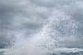 Splashing water of sea wave crashing on shore spraying white water foam