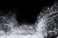 Splashing water of sea wave from strom crashing on shore spraying white water foam Royalty Free Stock Photo