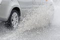 Splashing water from under the car wheels Royalty Free Stock Photo