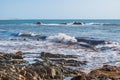 Splashing of a wave bursting with droplets, sea and rocks with seaweed and fog on the horizon, ApÃºlia PORTUGAL