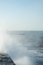 Waves crash on the pier. Sea spray. Beautiful seascape. Royalty Free Stock Photo