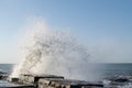 Waves crash on the pier. Sea spray. Beautiful seascape. Royalty Free Stock Photo