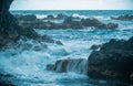 Splashing waves on the rock in the sea. Wave hit the stone in the ocean with a water background. Royalty Free Stock Photo