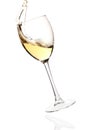 Splashing white wine in a falling glass Royalty Free Stock Photo