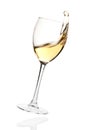 Splashing white wine in a falling glass Royalty Free Stock Photo