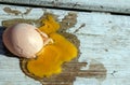 Splattered egg on a wooden deck. Royalty Free Stock Photo