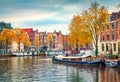 Splendid autumn scene of Amsterdam city. Famous Dutch channels and great cityscape. Colorful morning landscape in Netherlands, Eur