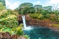 Splendid landscape of the Rainbow Falls waterfall in Hilo, Hawaii surrounded by green vegetation Royalty Free Stock Photo