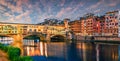 Splendid medieval arched river bridge with Roman origins - Ponte Vecchio over Arno river. Colorful spring sunset view of Florence Royalty Free Stock Photo
