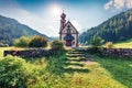 Splendid morning view of San Giovanni Church in St. Magdalena village. Sunny summer scene of Funes Valley Villnob with Odle
