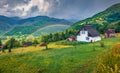 Splendid summer scene of mountain village with rainbow