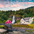 Splendid summer sunset with Large, popular waterfall Steinsdalsfossen on the Fosselva River. Picturesque evenig scene of  village Royalty Free Stock Photo