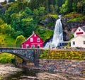 Splendid summer view with Large, popular waterfall Steinsdalsfossen on the Fosselva River. Picturesque morning scene of  village Royalty Free Stock Photo