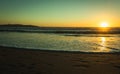 Splendid sunset with footprints on sand and city of Coquimbo Royalty Free Stock Photo