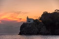A splendid sunset by the historic lighthouse, Faro di Portofino, at Portofino, Liguria, Italy.