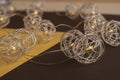 Splendid view of metallic spherical christmas decoration, lights. Beautiful combination of yellow and black backgrounds Royalty Free Stock Photo