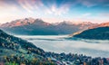 Splendid view of Zell lake in the morning mist. Foggy autumn sunrise of Austrian town - Zell am See, south of the city of Salzburg