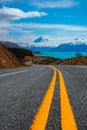 Splendid winding road with snowy Mount Cook and bluish Pukaki Lake in the background taken on a sunny day, New Zealand Royalty Free Stock Photo